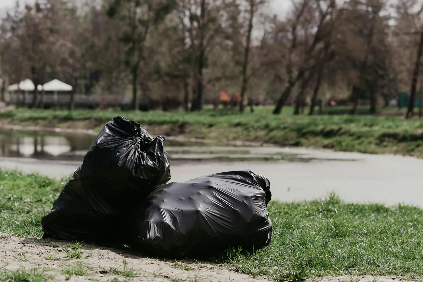 Black trash bags set out for weekly garbage pickup in Hubbard