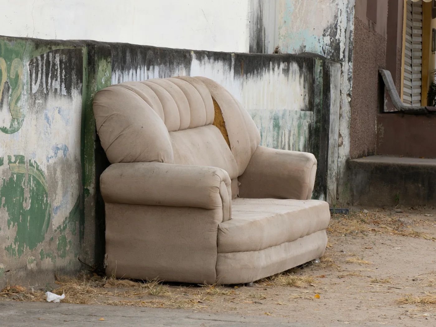 Discarded armchair set out for furniture removal pickup